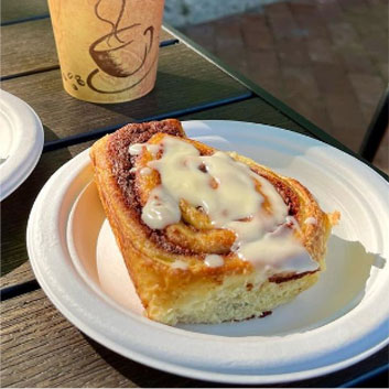 fresh cinnamon buns with a cup of coffee