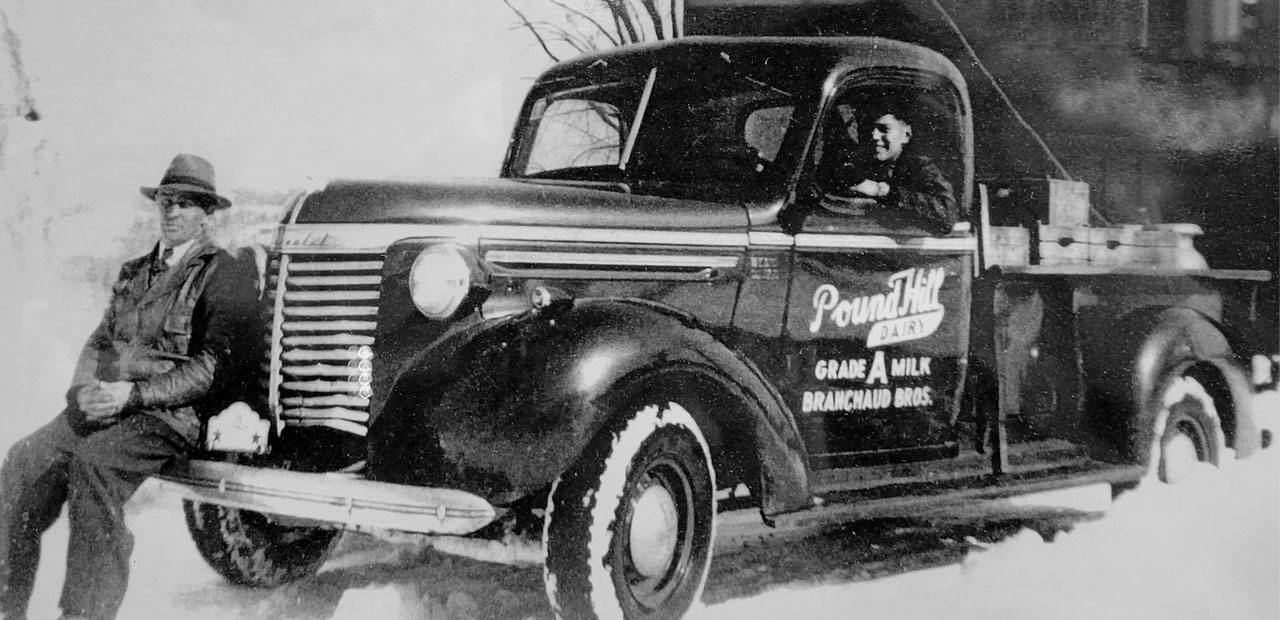 A vintage photo of aPound Hill Dairy truck and driver