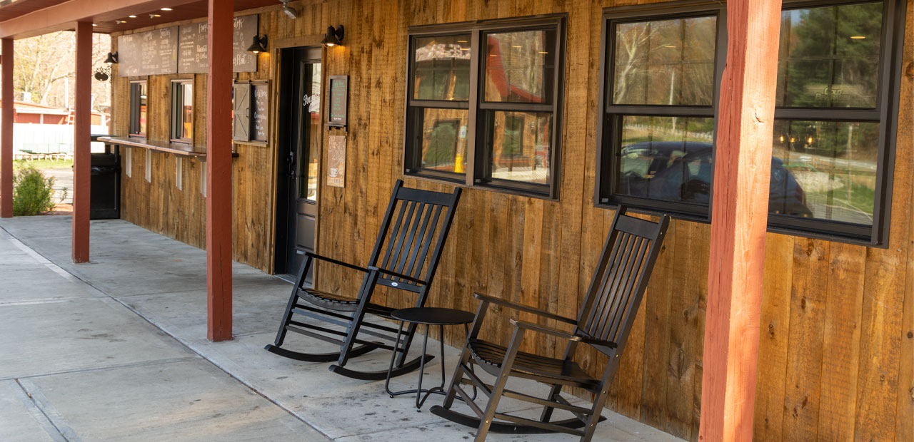 Adirondac chairs on the front patio of the cafe