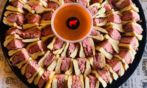 Beef Barn catering tray of roast beef sandwich wedges and dipping sauce