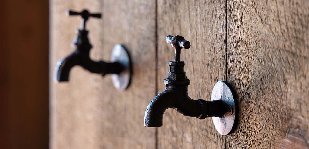 Rustic water spigots mounted to the wall