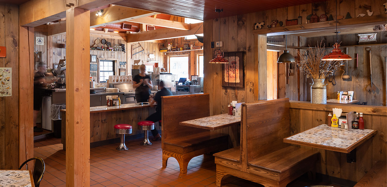 A customer at the counter enjoying a great roast beef sandwich