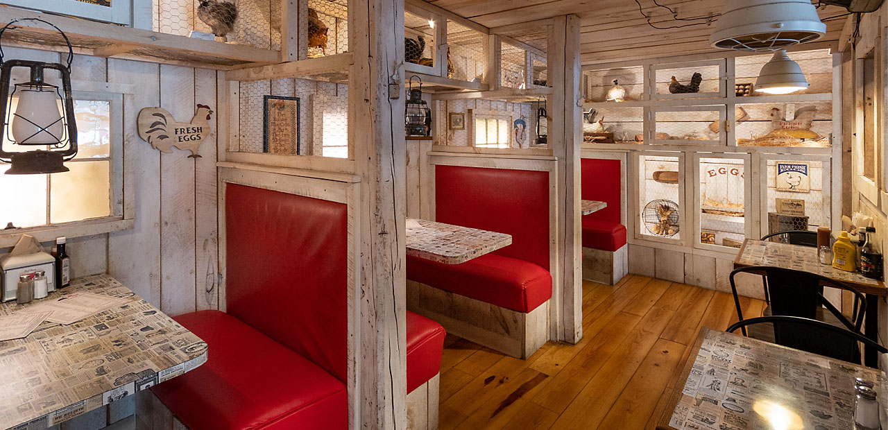 A wide view of the booths and tables inside the Chicken Coup dining room