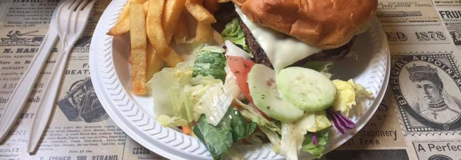 a Beef Barn cheeseburger shown with a side of french fries and small salad